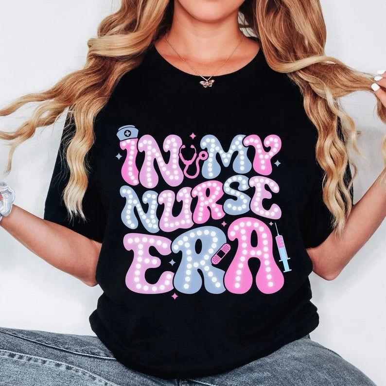 In My Nurse Era Doodle Letters Direct to film on Black Gildan T-Shirt